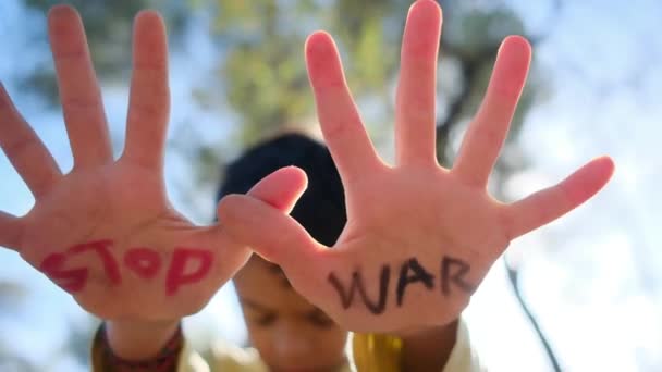 Jongen Met Stop Oorlog Woorden Palmen Close — Stockvideo