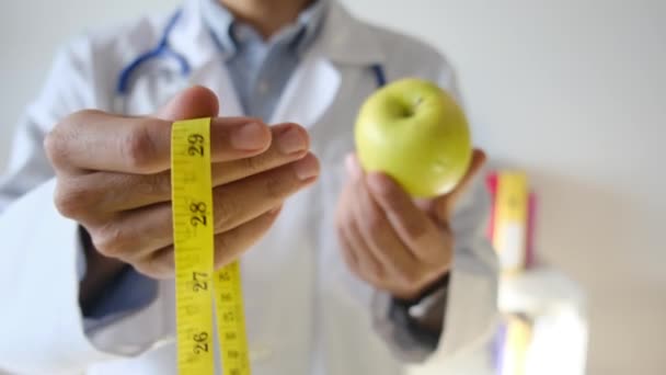 Young Doctor Holding Apple Measuring Tape — Stock Video