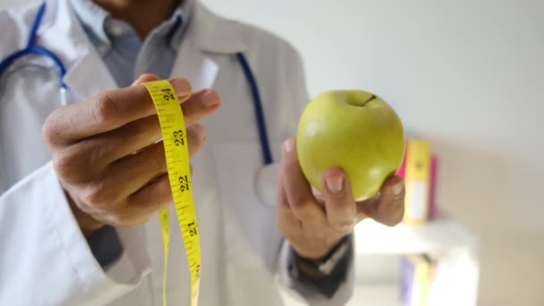 Młody Lekarz Trzymający Jabłko Taśmę Pomiarową — Wideo stockowe
