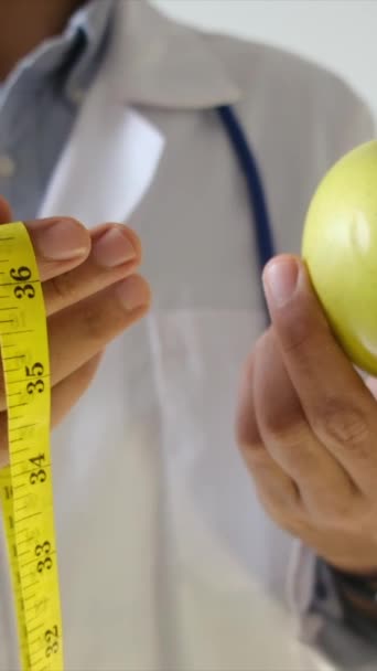 Young Doctor Holding Apple Measuring Tape — Stock Video