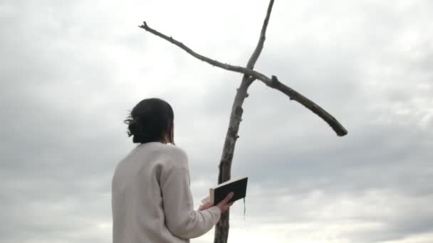 Kobieta Modląca Się Biblią Pobliżu Drewnianego Krzyża Górach — Wideo stockowe