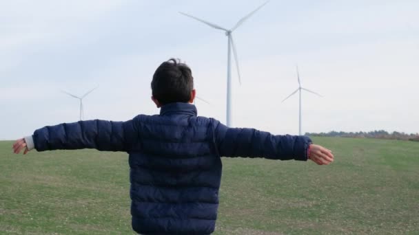 Boy Hands Outstretched Countryside Looking Wind Turbines Ecology Concept — Stock Video