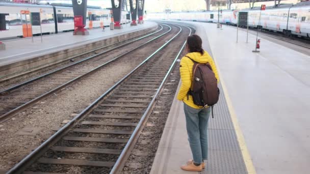 stock video young woman traveler with backpack  on train station platform 