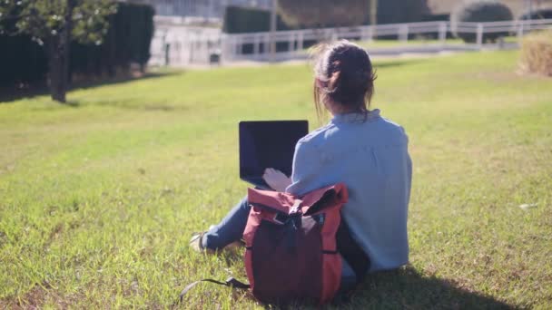 一名大学生带着笔记本电脑在校园里专心致志地学习 对自己的网上学习充满了信心 她拥抱了户外的宁静 — 图库视频影像