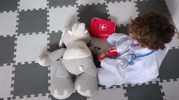 Little Boy Wearing Medical Robe Stethoscope Playing Toy Elephant — Stock Video