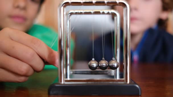Little Boys Studying Newton Pendulum Table — Stock Video