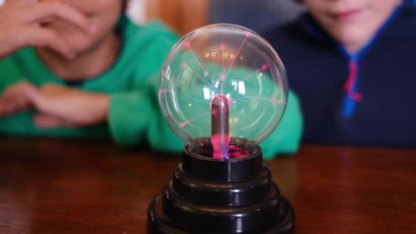 Little Boys Studying Plasma Ball Lightning Table — Stock Video