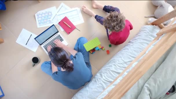 Top View Woman Working Laptop Her Son Playing Toy Building — Stock Video