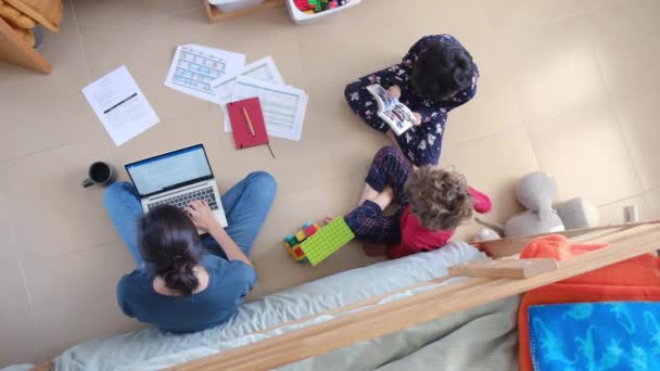 Top View Woman Working Laptop Her Sons Playing Floor Home — Stock Video