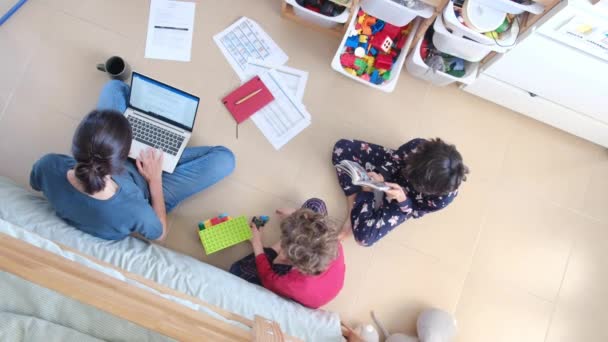 Top View Woman Working Laptop Her Sons Playing Floor Home — Stock Video