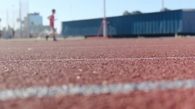 Stadyumdaki spor pistlerinde spor yapan bulanık insanların alt görünümü