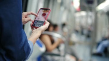 Metroda Smartphone kullanan genç kadın 