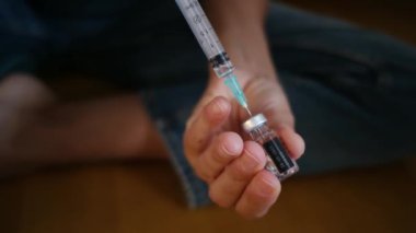 Kadın şişeden şırıngayla ilaç alıyor.. 