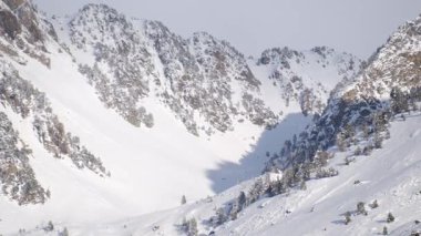 Görkemli, karla kaplı dağların hava aracı görüntüleri..