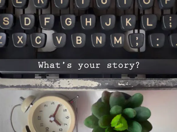 Motivational and inspirational wording. Whats Your Story written on the spacebar of a typewriter. With blurred style background.
