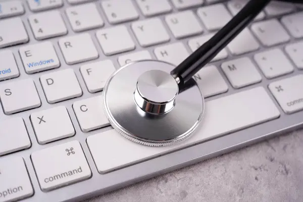 Health and medical or management stability concept. A stethoscope placed on a keyboard. Blurred styled background.