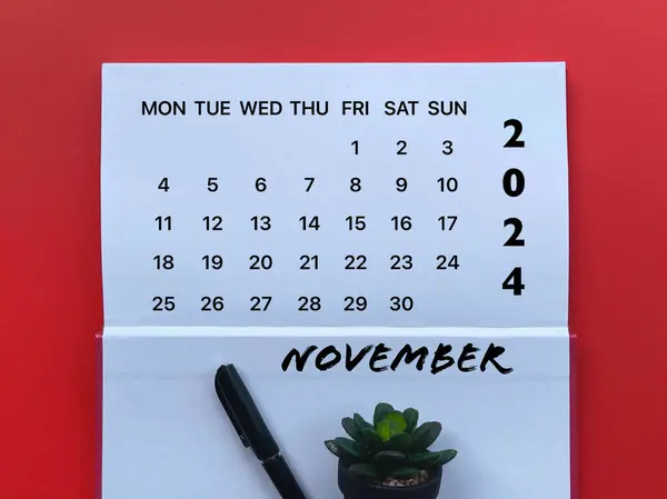 stock image Month, time and calendar concept. Calendar for month of NOVEMBER 2024 on a notepad.