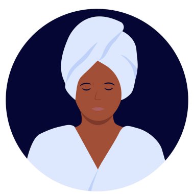 a relaxed woman in a bathrobe and with a towel on her head after taking a shower