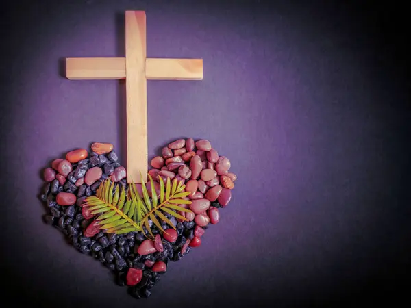 stock image Lent Season,Holy Week and Good Friday concepts - photo of wooden cross with palm leaves and stones in purple vintage background