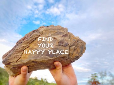 Inspirational Motivational Concept - find your happy place written on rock. clipart