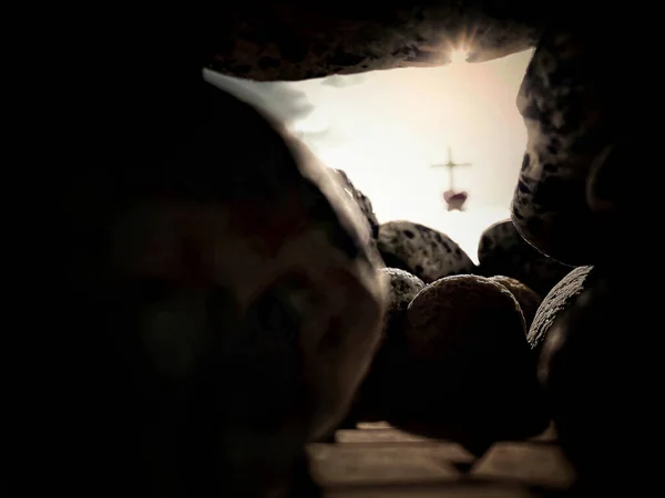 Lent, Holy Week, Easter Sunday, Good Friday Concept - view from inside Jesus Christ empty tomb, grave of resurrection with blurry cross shape background. Stock photo