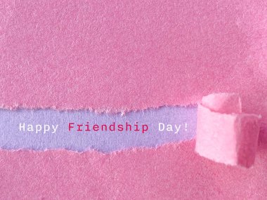 Celebration Happy friendship day text on torn paper background. Stock photo. clipart