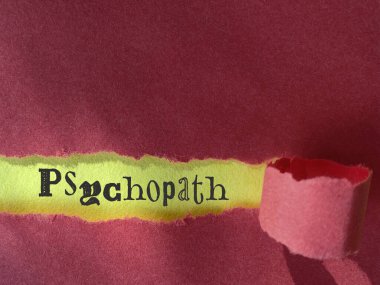 Psychopath text behind torn paper background. Stock photo. clipart