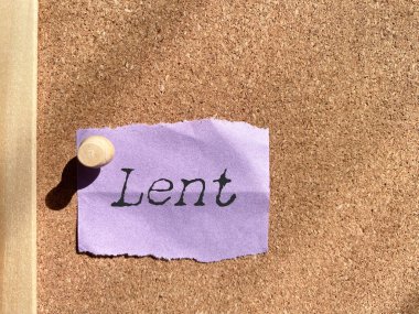 Lent text on paper with bulletin board background. Stock photo. clipart