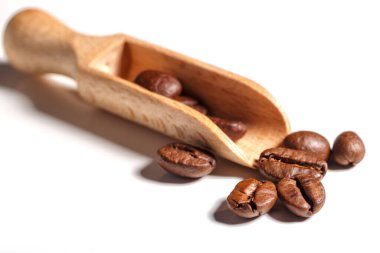 Beyaz arkaplanda paket tasarımı elementleri olarak izole edilmiş taze kahve çekirdekleri yığını.