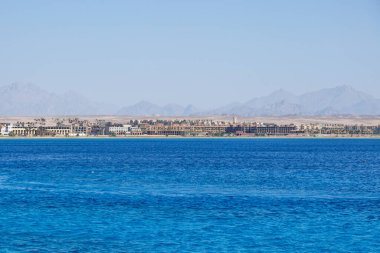  Hurghada, Egypt. . Buildings, swimming pools and a recreation area by the red sea.  clipart