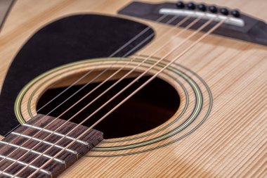 Klasik gitar, yakın çekim. Ahşap arka planda akustik gitar. Müzik aleti konsepti.