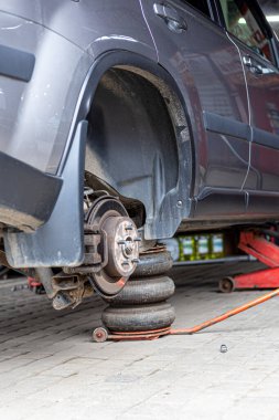 Lastik servisi. Sıkıştırılmış hava aracı. Arabanın lastiklerini değiştirmek, araba tamirciliği, yeni lastik değiştirme işlemi, garajda araba freni tamiri..