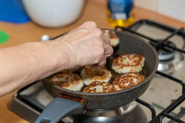 stock image Meat burgers or cutlet-shaped patty being shallow fried in oil on a frying pan, close up. version of cutlets - kotlety.