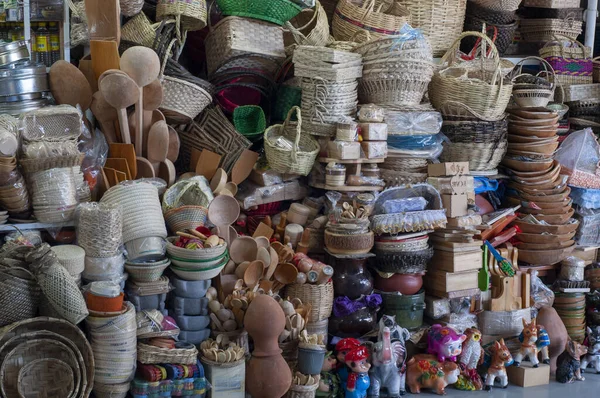 pieces of crafts in a craft market, baskets, vessels, wooden cutlery and handmade toys
