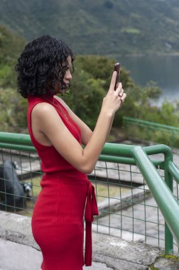 Attractive girl taking a selfie by the lagoon