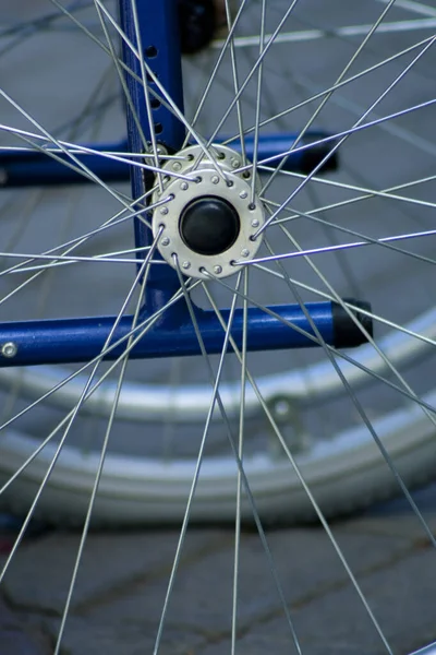 closeup of the axle and spokes of a standing wheelchair. This photo is perfect to represent concepts associated with health, the elderly and other diseases or nursing homes