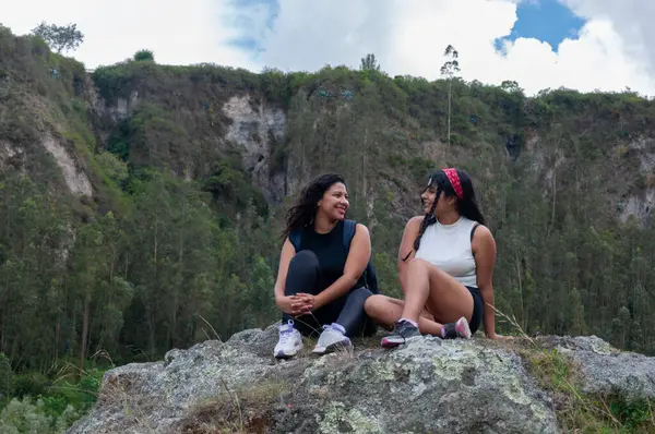 two smiling friends on top of a mountain in ecuador on their vacation enjoying rural tourism. High quality photo
