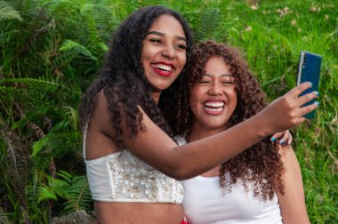 Z neslinin iki arkadaşı bir dağda takipçileri için içerik oluşturuyorlar, çok mutlu ve gülümsüyorlar. Yüksek kalite fotoğraf
