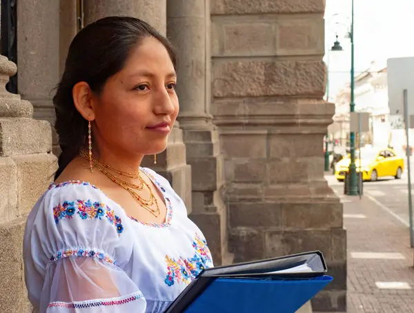 Canlı bir şehir ortamında, genç bir kadın kendine güvenerek poz verir ve büyüleyici geleneksel giysiler giyer.