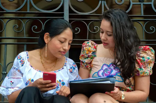 İki arkadaş, yeşil ve güneş ışığı olan renkli bir ortamda aletlerini kullanarak neşeli bir şekilde konuları tartıştılar.