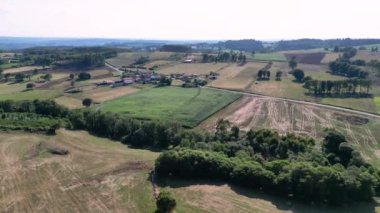 Panoramic View Of Rural Landscape With Dwellings And Fields In The Sunny Daytime. Aerial Shot
