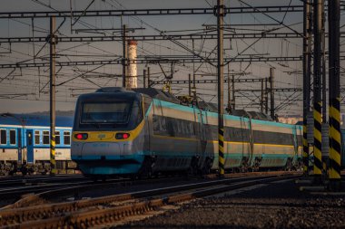 Prag ana istasyonunda sonbaharda güneşli bir gecede Çek Cumhuriyeti renginde süper hızlı tren.