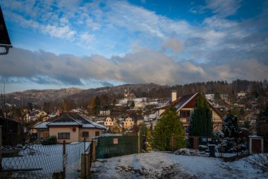 Liberec şehrindeki eski kilise ve evler kışın karlı, taze bir günde