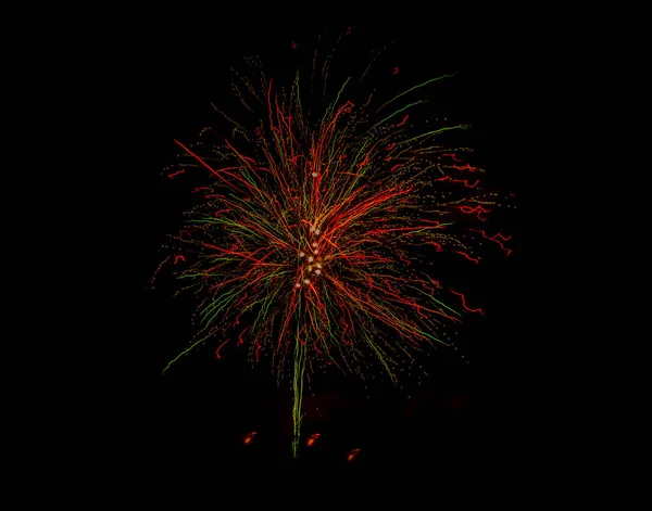 Color fireworks on black sky in New Year midnight