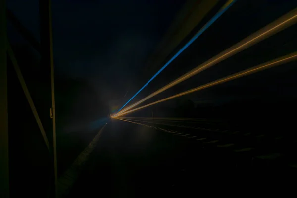 NIght dark color train lines in night between Prague and Tabor towns in Czech republic