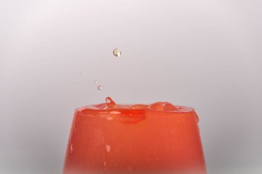 Color drops fall to wine glass with color light liquid