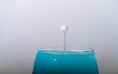 Color drops fall to wine glass with color light liquid