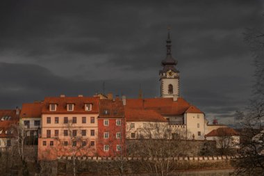 Old stone bridge and center of Pisek town in cloudy winter windy morning