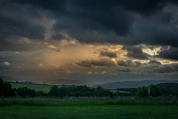 Cloudy sunset near Roprachtice village and Vysoke nad Jizerou town in summer evening