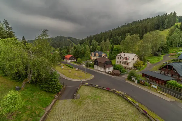 stock image View for mountains village with cloudy fresh sunset colors in Nove Hamry CZ 06 27 2024